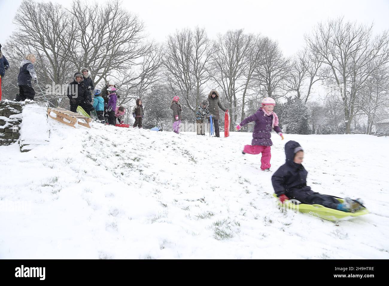 Tabogganists enjoy the snow on the slopes of Brent Valley golf course in west London Stock Photo