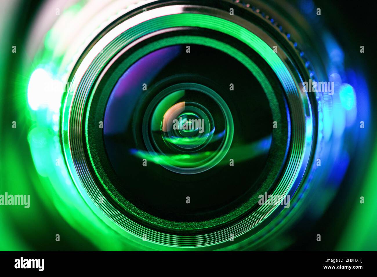 The camera lens and green backlighting. Green camera Lens close Up. horizontal photo Stock Photo