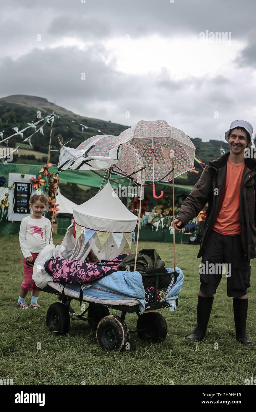 Mia and Martin Robinson with their waterproofed pram in preparation for rain on day 2 of the Greenman 2013 festival in Glanusk, South Wales. Against the forecast, day 1 provided some beautiful sunshine Stock Photo