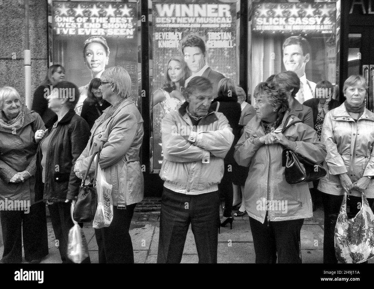 Theatre-goers waiting to be picked up after attending a performance of the Body Guard in London's west end (part of a series of images taken and processed on the iPhone by winner of the Terry O'Neill award mobile category, Richard Gray) Stock Photo
