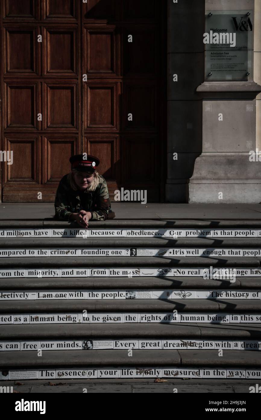 Artist Carrie Rehchardt at the opening of the Disobedient Objects exhibition at the Victoria & Albert Museum in London. Two of her ceramic collages flank the entrance to the Museum and the steps of the entrance carry quotes by and testimonials to famous protesters. The exhibition brings together objects that have been used in grassroots protests and social movements. Stock Photo