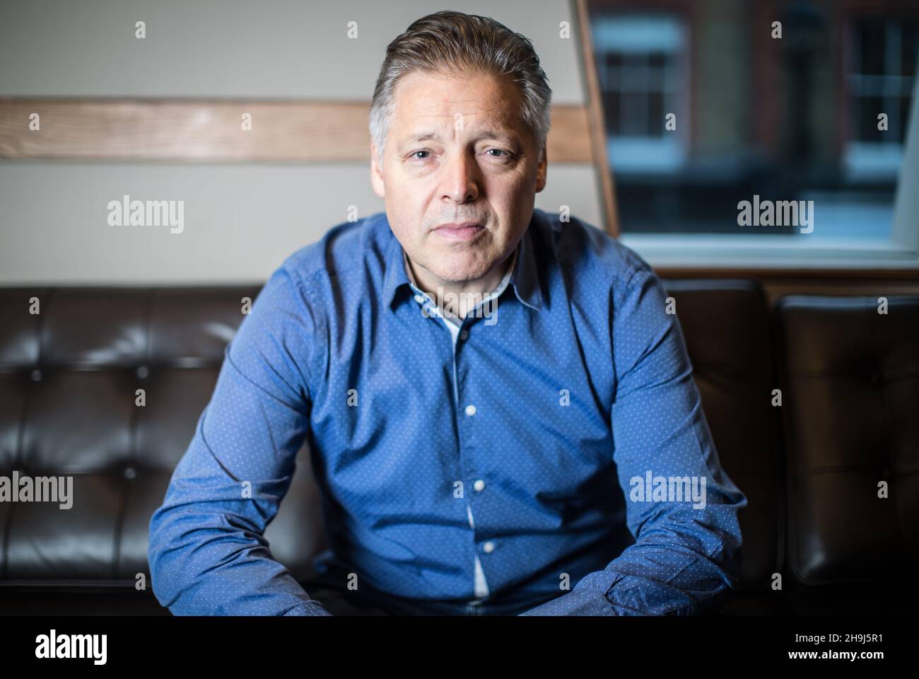 Portraits of Mark Goodier, founder and boss at Wise Buddah production company, and formerly a DJ with BBC Radio 1 (Images taken in the studios of Wise Buddah production company). Stock Photo