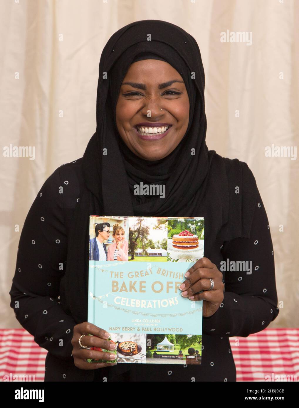 Nadiya Hussain, winner of the BBC series The Great British Bake Off, poses for photos at the Picaddilly branch of Waterstones in London before a book-signing after the announcement of the winner yesterday. Stock Photo