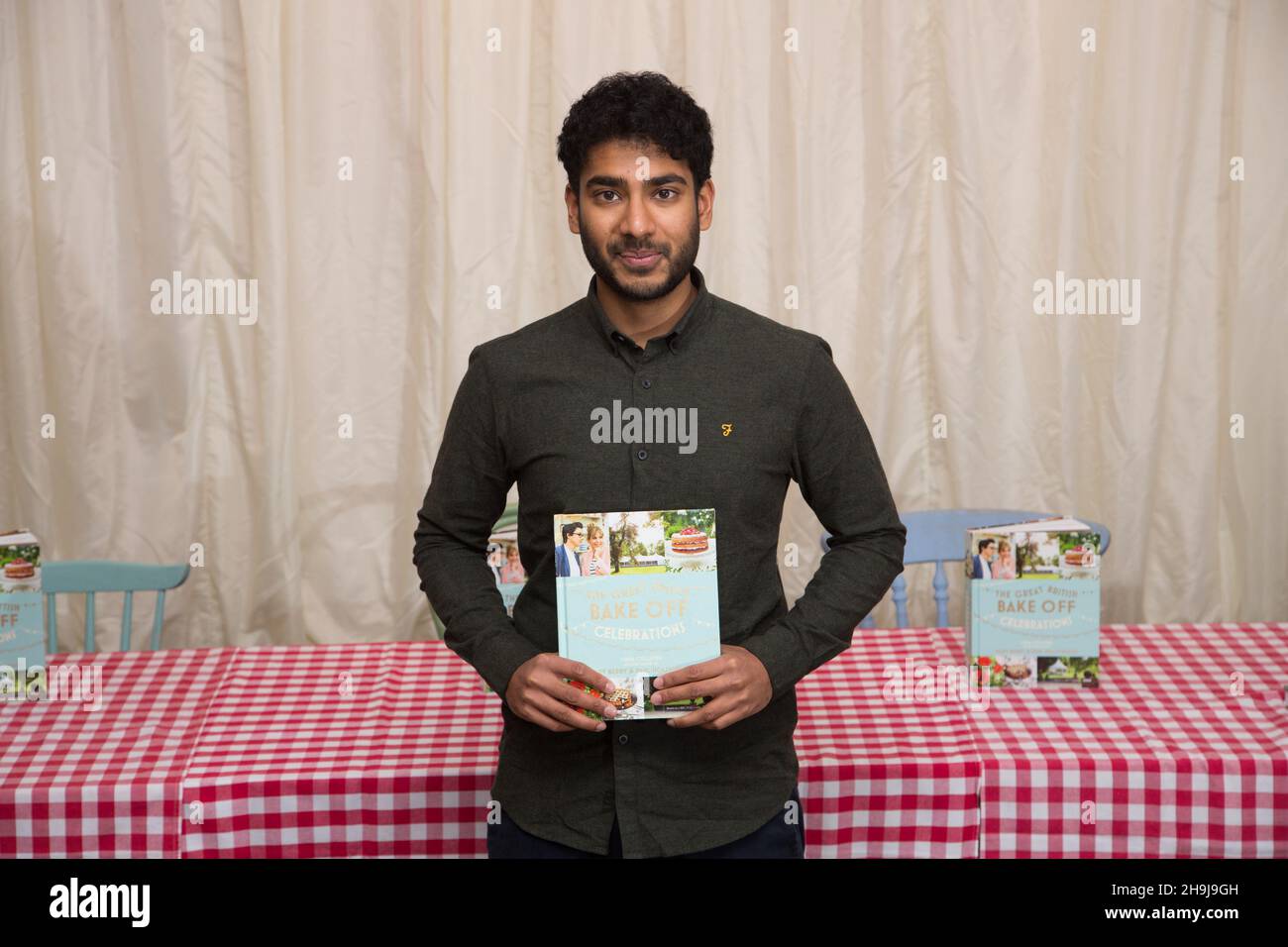 Tamal Ray, a finalist in the 2015 BBC series The Great British Bake Off, poses for photos at the Picaddilly branch of Waterstones in London before a book-signing after the announcement of the winner yesterday. Stock Photo