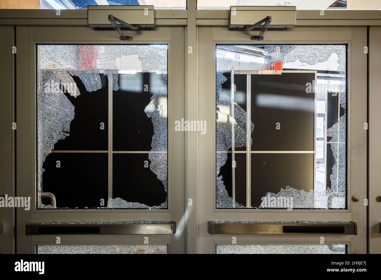 Broken panes of glass in doors. This location has since been demolished. Stock Photo