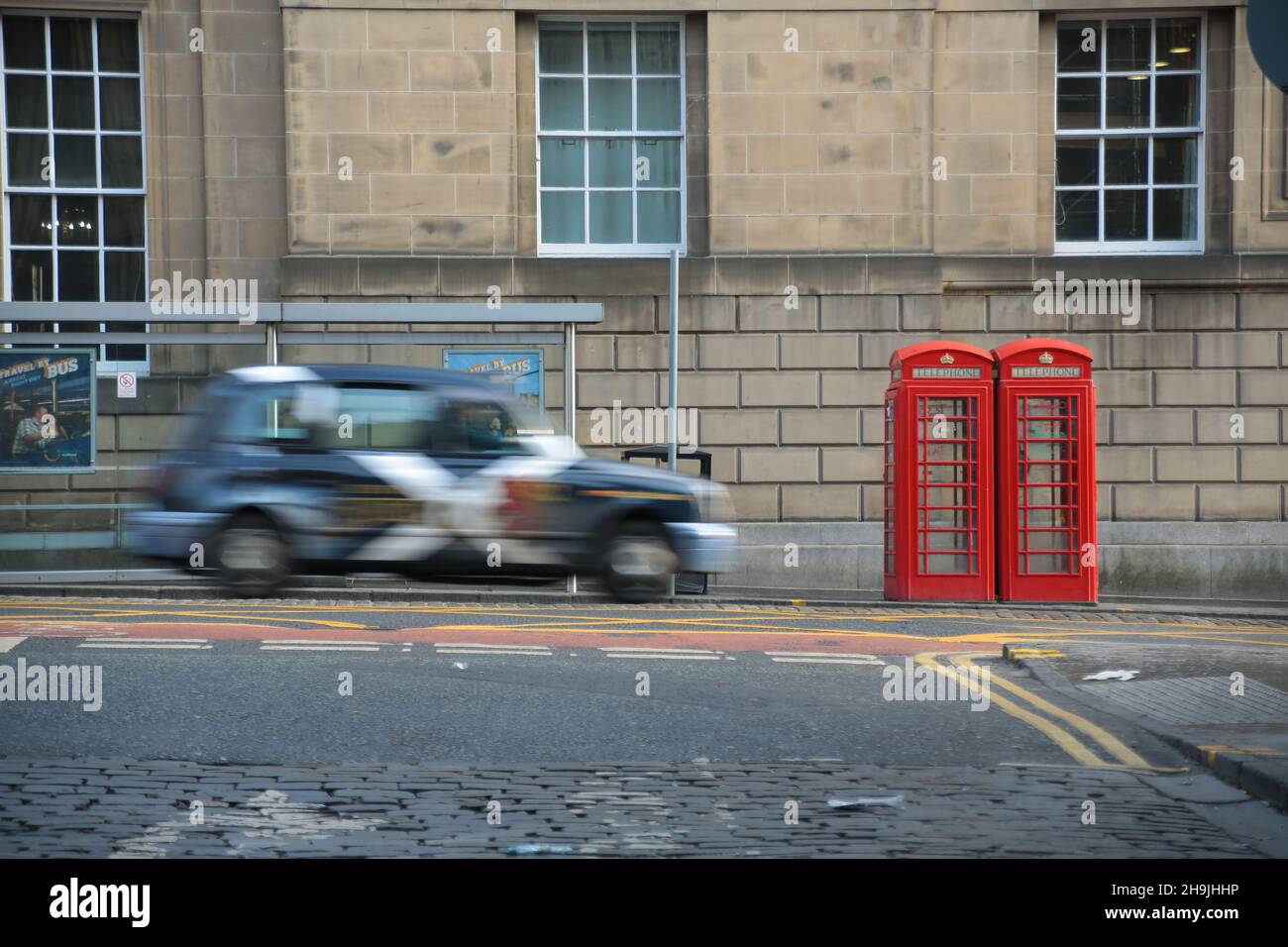 A taxi next to two old red phone boxes in the old town of Edinburgh. From a series of general views of Edinburgh, Scotland. Photo date: Monday, February 6, 2017. Photo credit should read: Richard Gray/EMPICS Entertainment Stock Photo