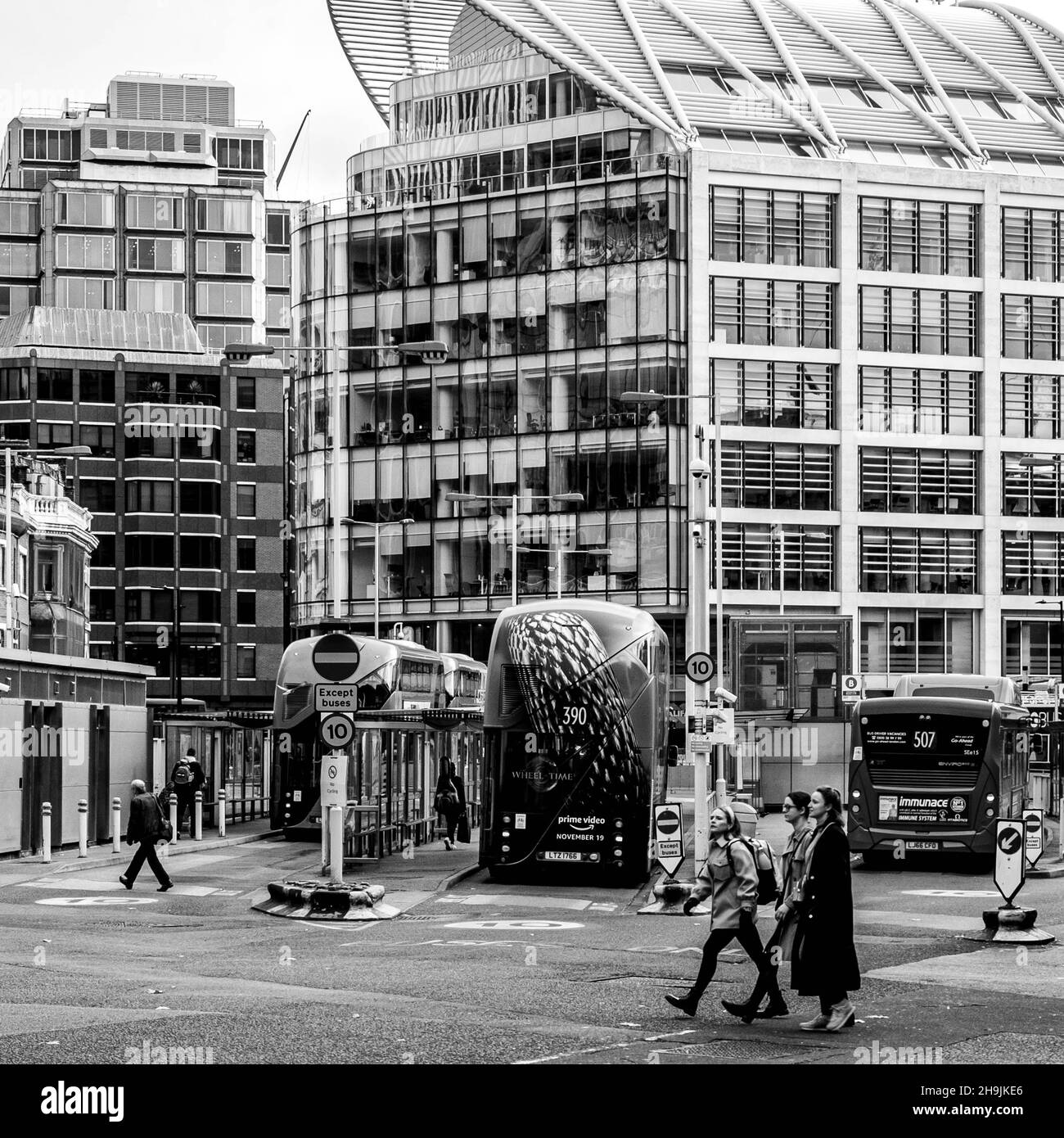 Central London UK November 21 2021, Victoria Bus Station London With People Walking And Parked Busses With A High Rise Commercial Office Building In T Stock Photo