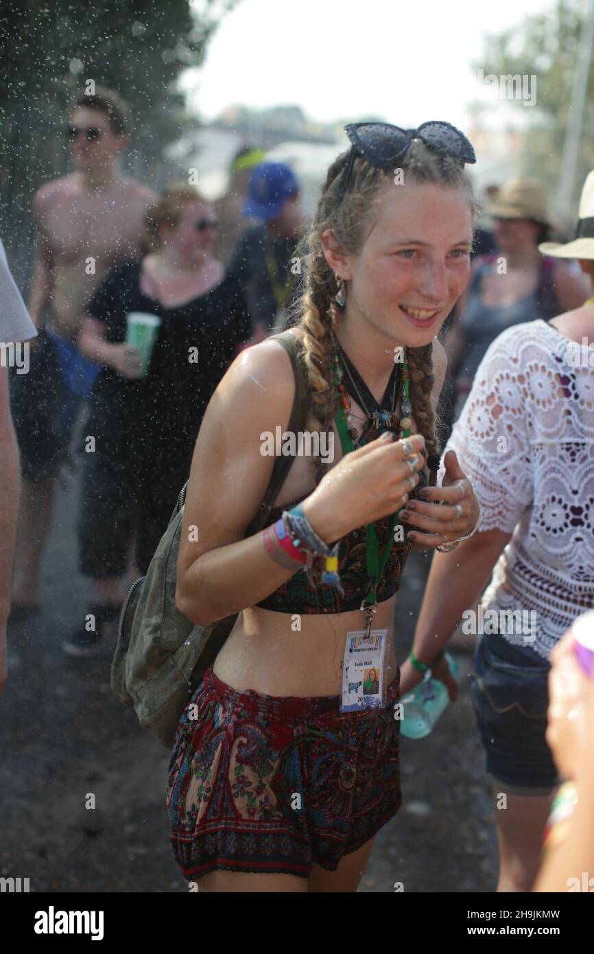 A woman is doused by Shepton Mallet firemen on a very hot Day 1 (Wednesday) of the 2017 Glastonbury Festival at Worthy Farm in Somerset. Photo date: Wednesday, June 21, 2017. Photo credit should read: Richard Gray/EMPICS Entertainment Stock Photo