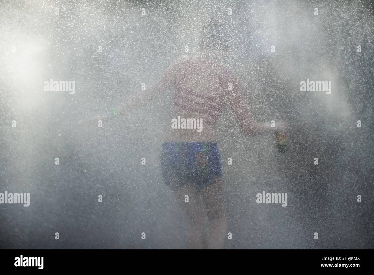 A woman is doused by Shepton Mallet firemen on a very hot Day 1 (Wednesday) of the 2017 Glastonbury Festival at Worthy Farm in Somerset. Photo date: Wednesday, June 21, 2017. Photo credit should read: Richard Gray/EMPICS Entertainment Stock Photo