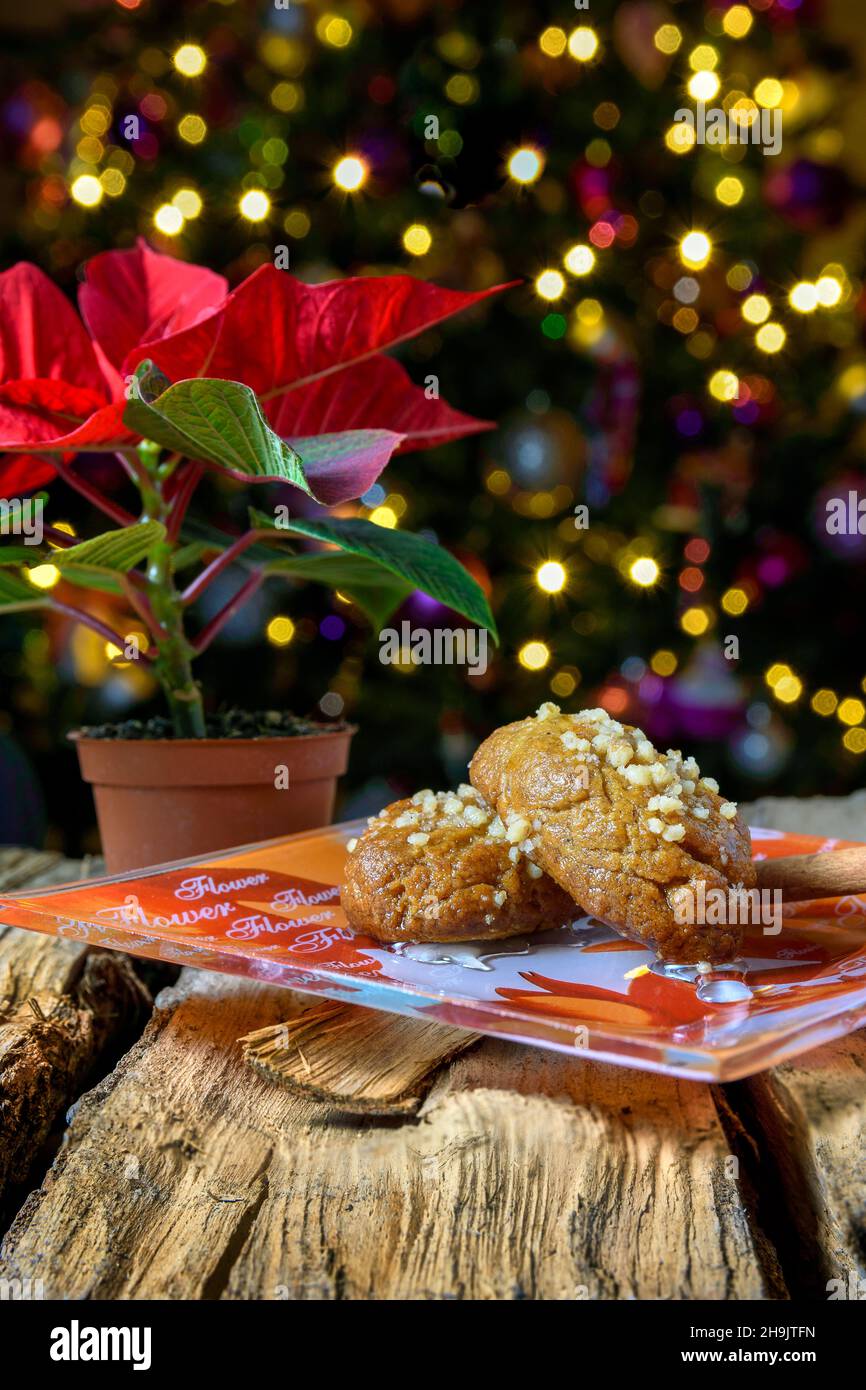Melomakarona, Greek traditional Christmas sweet, with a background of the Christmas tree and a flower Stock Photo