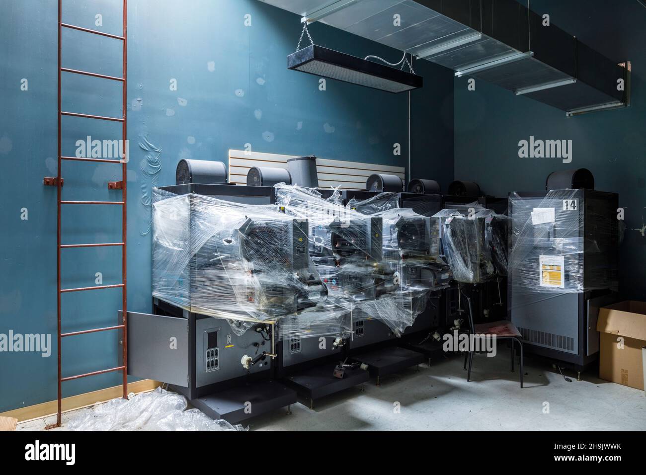 Analogue movie projectors wrapped in plastic.  This location has since been demolished. Stock Photo