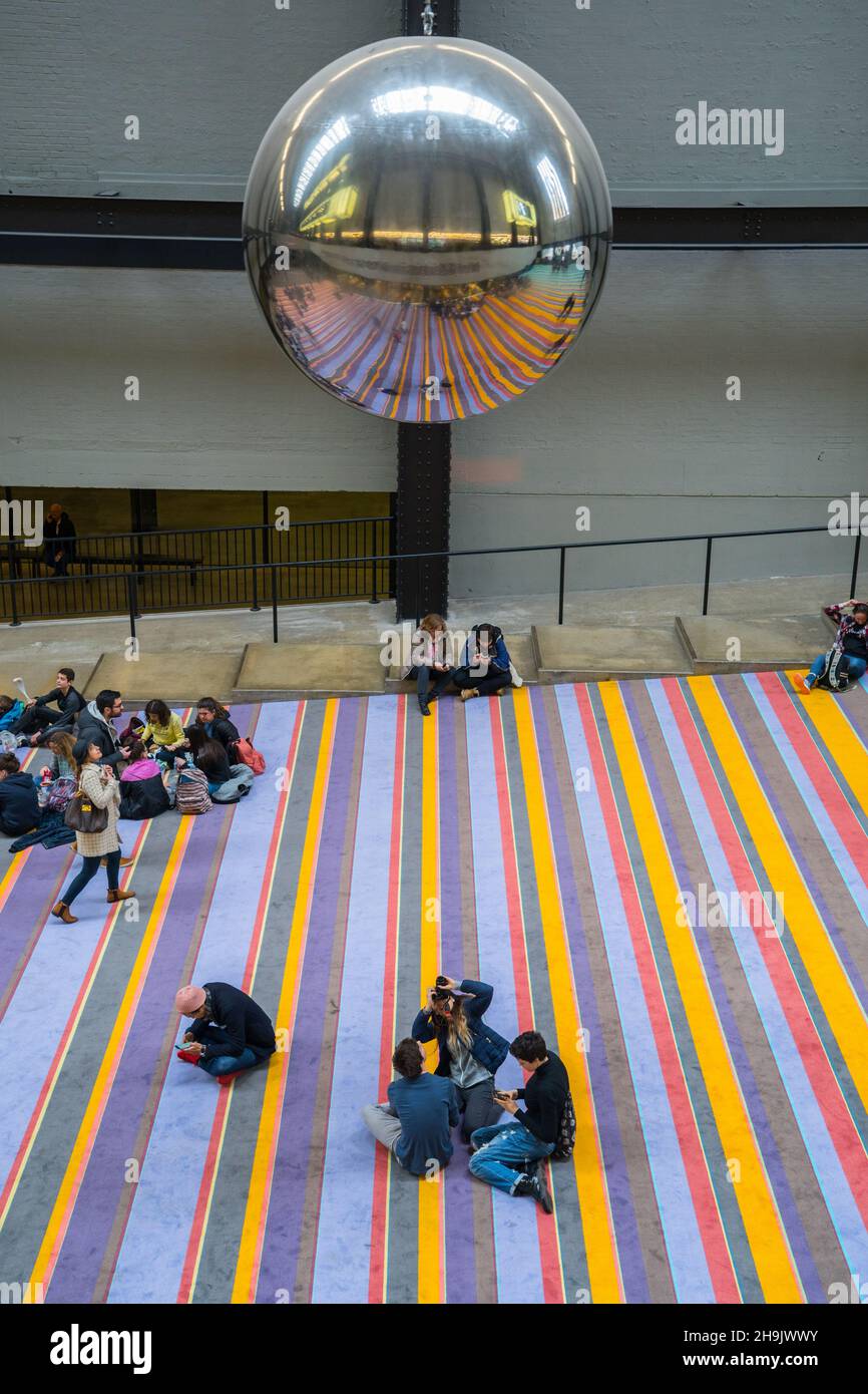A huge reflective metal ball swings in the Turbine Hall of the Tate Modern part of Danish art collective Superflex interactive installation called One Two Three Swing Photo date Thursday March 15