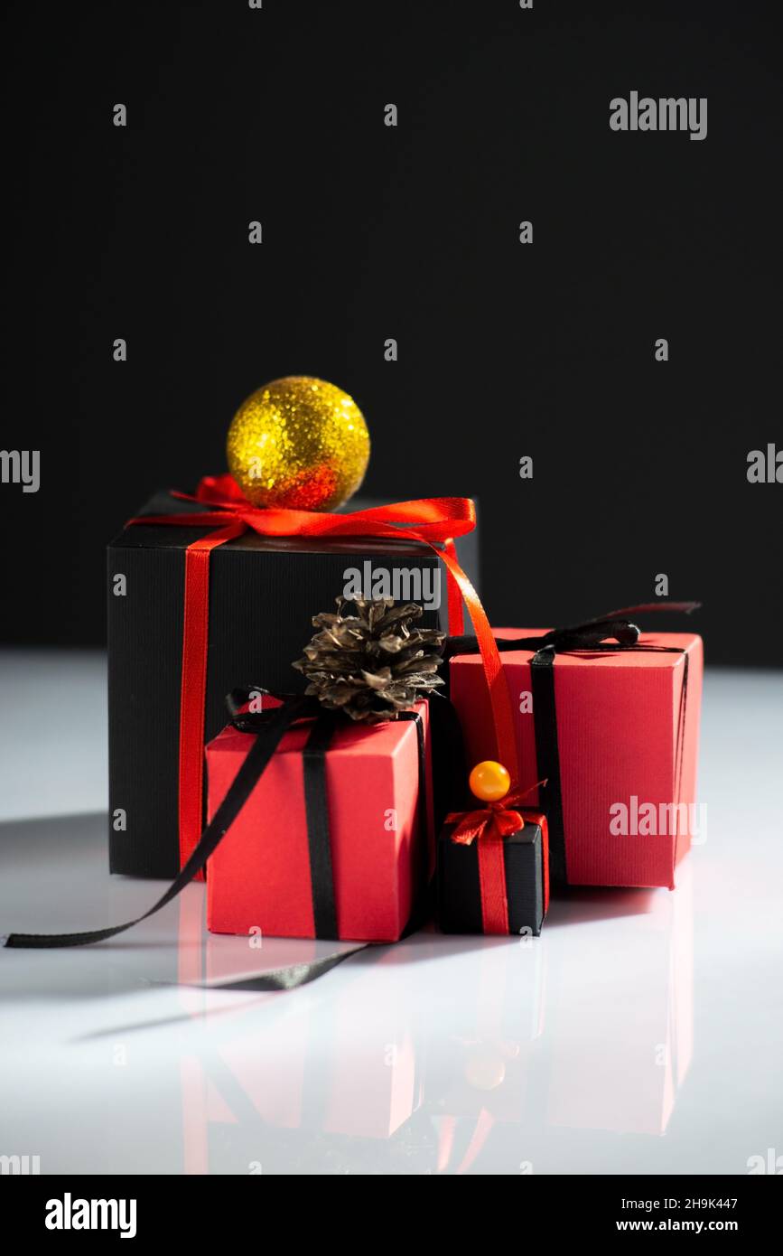 creative new year gifts red-black on white table and dark background Stock Photo