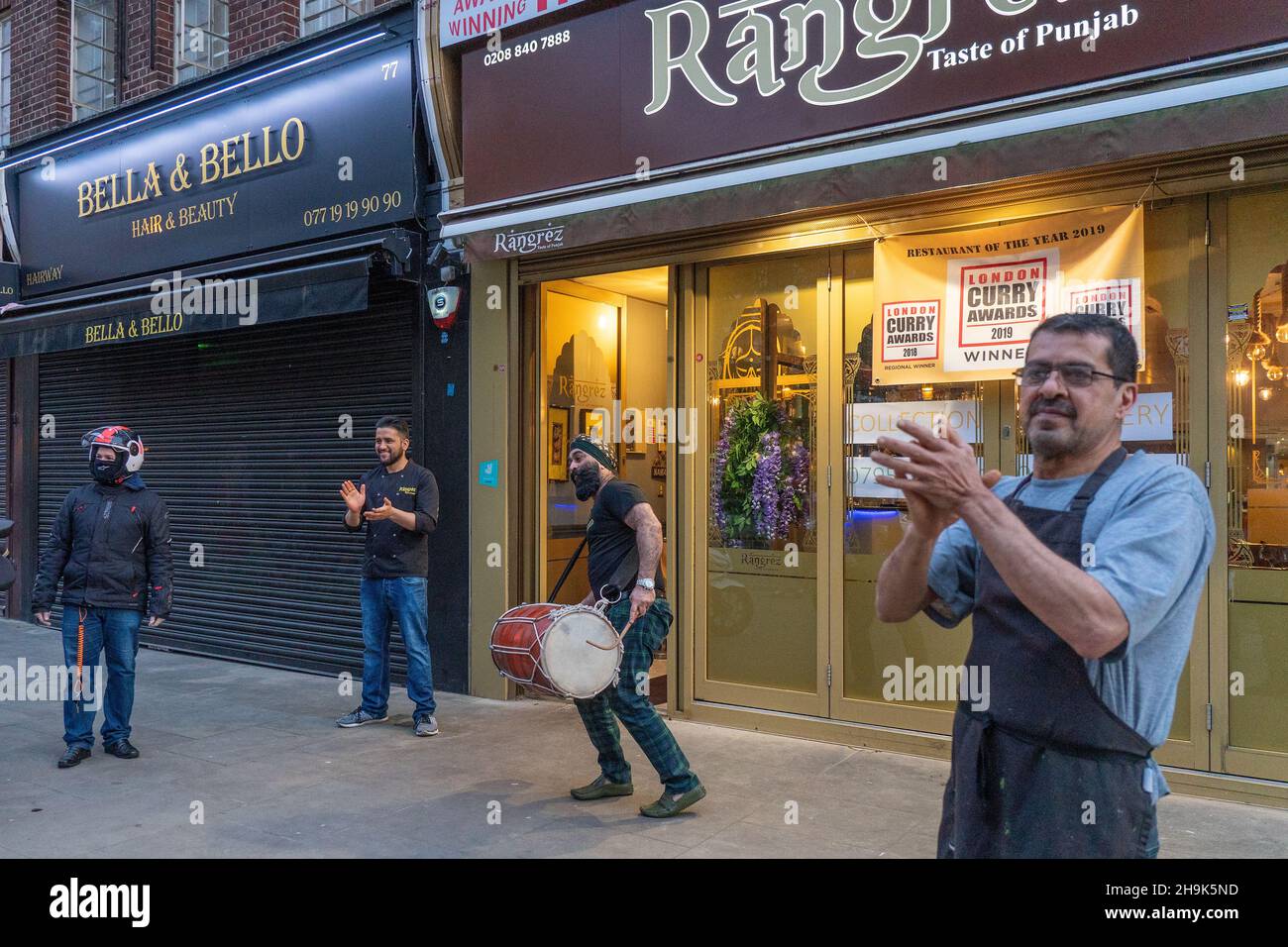 Staff at the Rangrez restaurant in Ealing applauding delivery workers ...