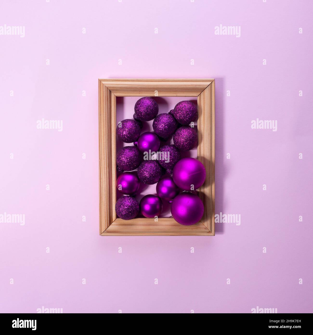 Christmas decorations in photo frame on pink background Christmas concept Stock Photo