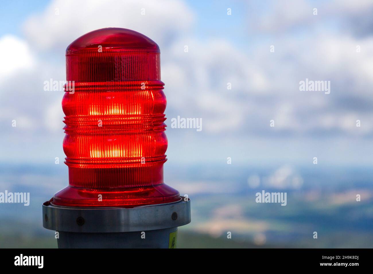 Red warning lights for air traffic on roof of high building, airport ...