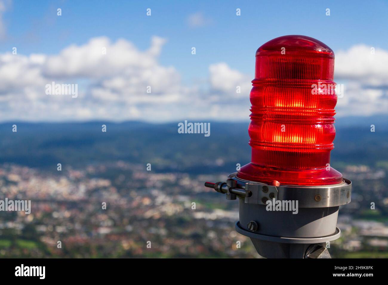 Red warning lights for air traffic on roof of high building, airport lighting equipment, daylight Stock Photo