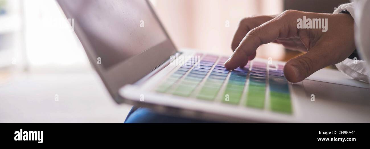 Close up of hand writing and typing on laptop keyboard. Concept of online modern work and office activity with people Stock Photo