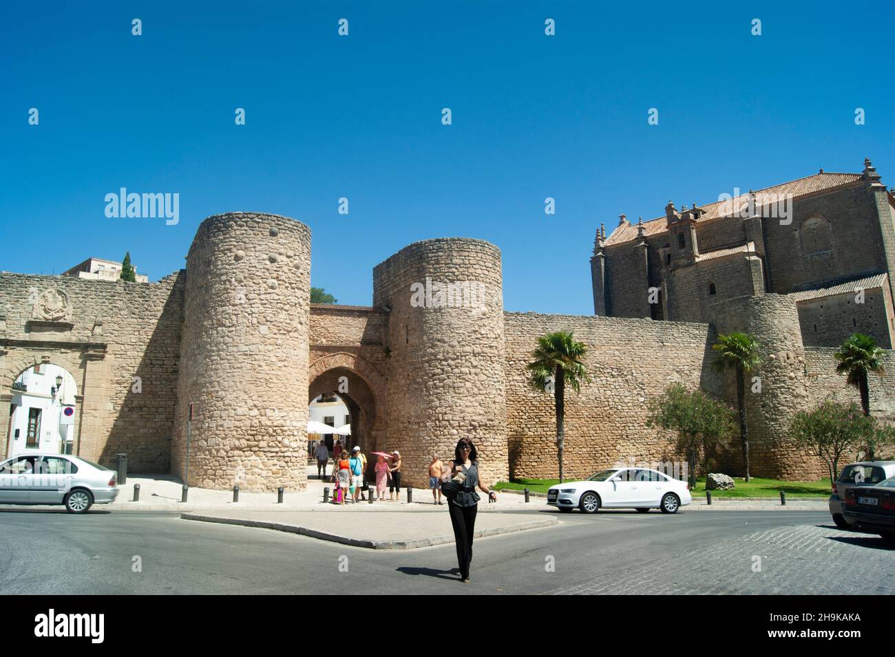 Ronda - Spain - August 15 2012 :  Dramatic medieval city walls. Defensive Almocabar gate. Stone historic landmark. Stock Photo