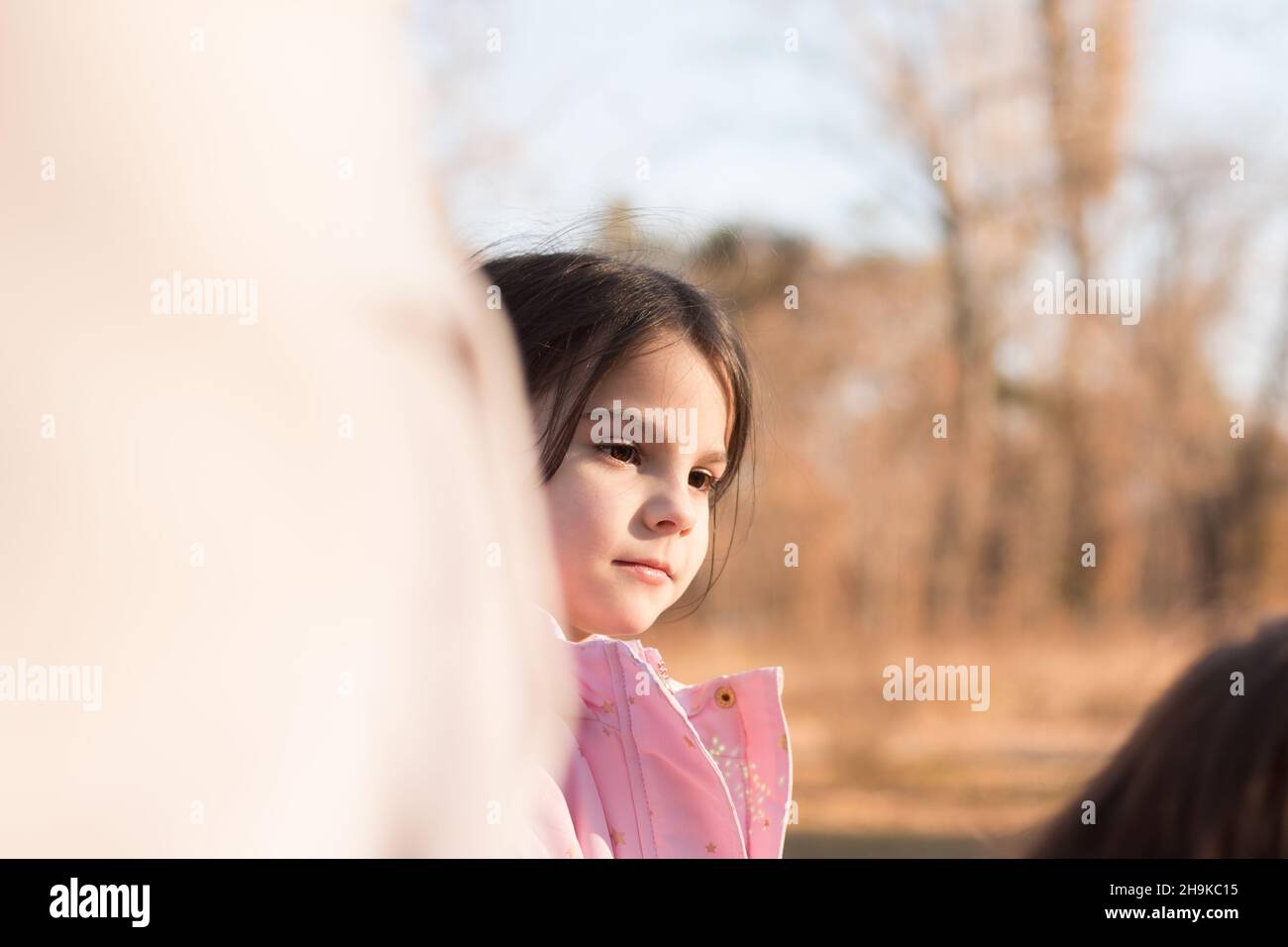 Little girl in a pink jacket in an autumn park Stock Photo - Alamy