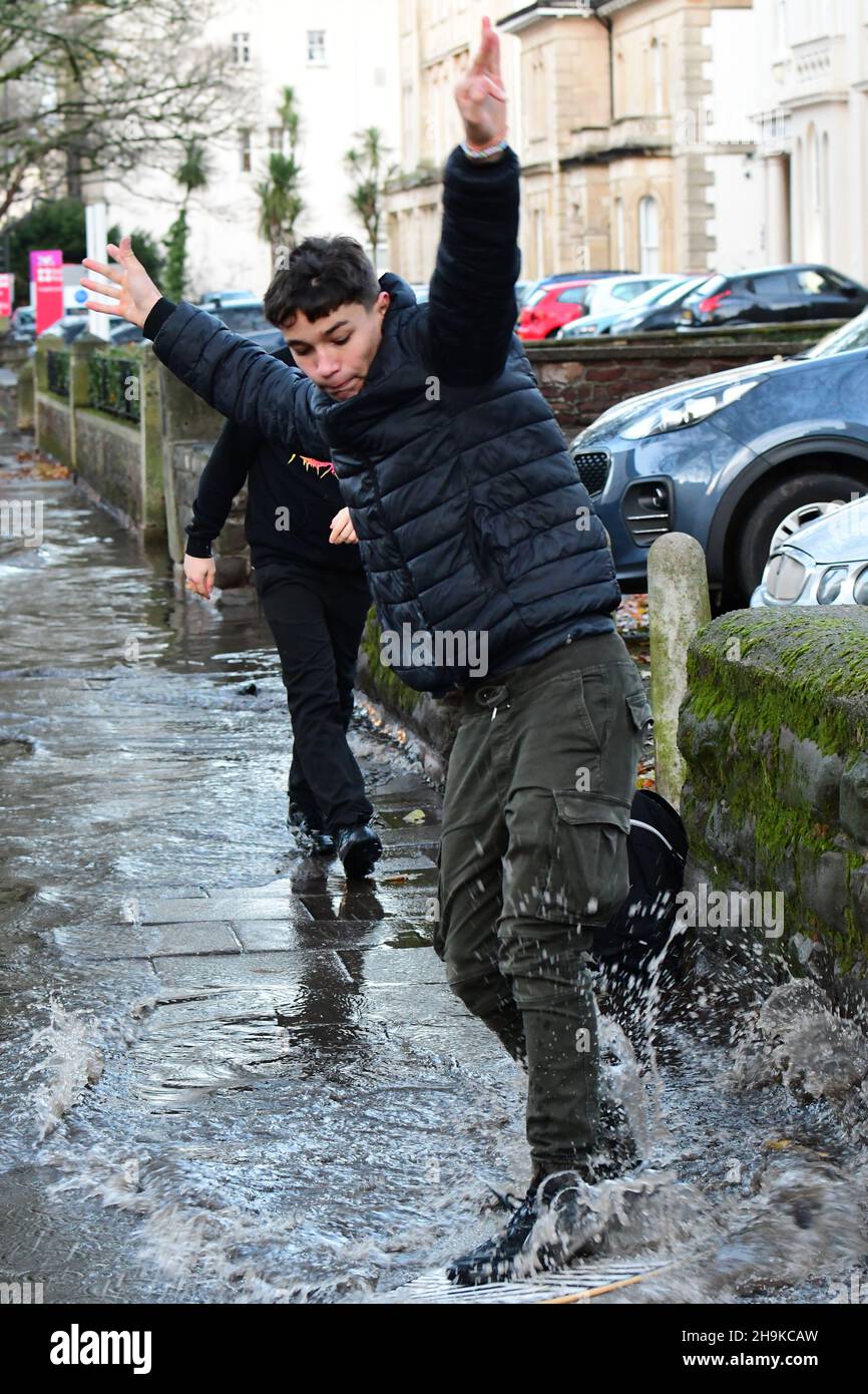 Bristol, UK. 07th Dec, 2021. Heavy Flash flooding on Whiteladies Road in Bristol in the afternoon, with lots of deep water and Boys trying Water Surfing on flood water. Picture Credit: Robert Timoney/Alamy Live News Stock Photo