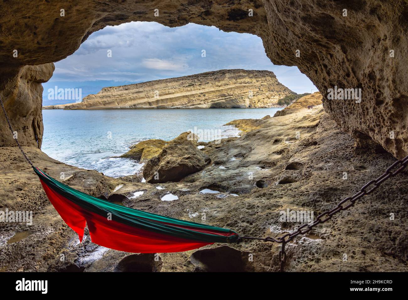 Matala beach with caves on the rocks that were used as a roman cemetery and at the decade of 70's were living hippies from all over the world, Crete, Stock Photo
