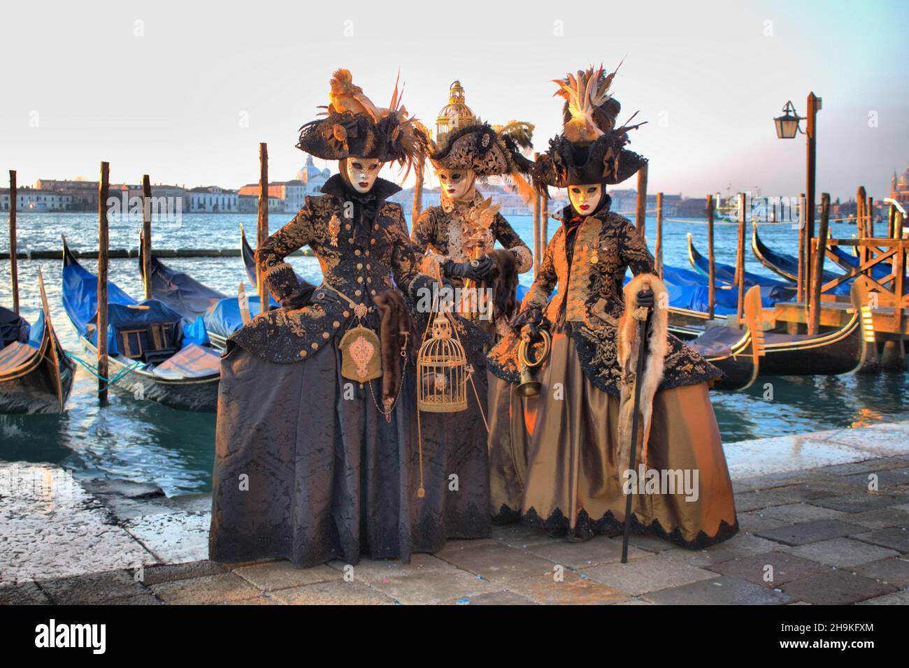 Venice, Italy - February 10, 2018: Three people in Venetian costume attends the Carnival of Venice, Italy Stock Photo