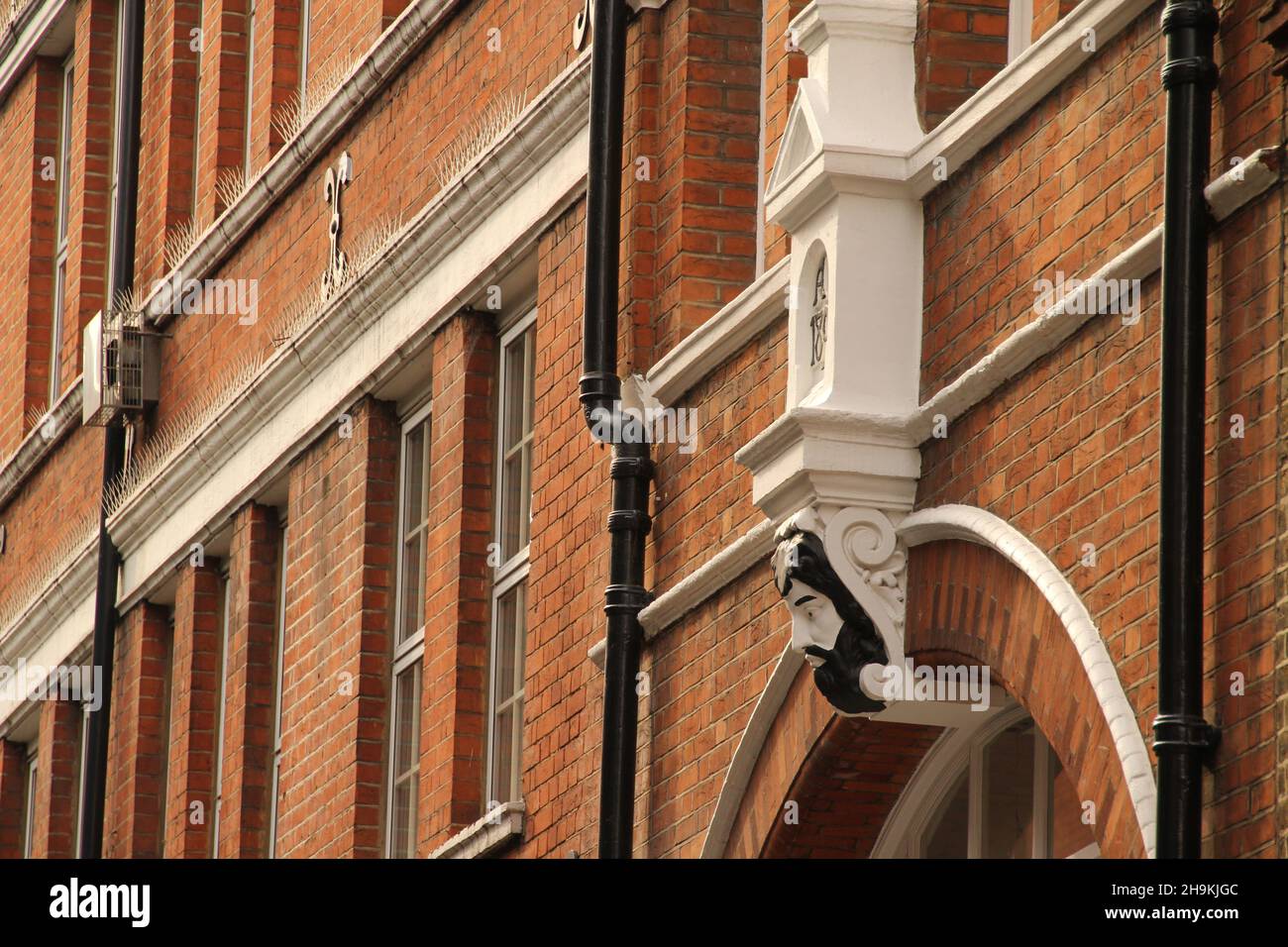 A Row of Brick Buildings with Black Doors on a Street in London Stock Image  - Image of architecture, english: 189002149