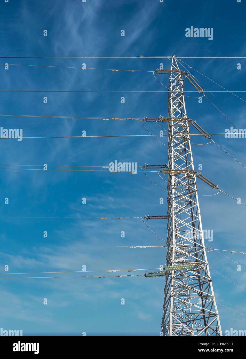 Power line, high voltage power line pylon. Cloudy sky background ...