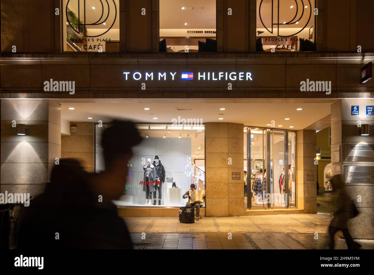 Tommy Hilfiger. People go shopping in Munich, Germany on December 7, 2021.  From December 8 there will be the 2G rule, meaning one has to be vaccinated  against the coronavirus or recovered