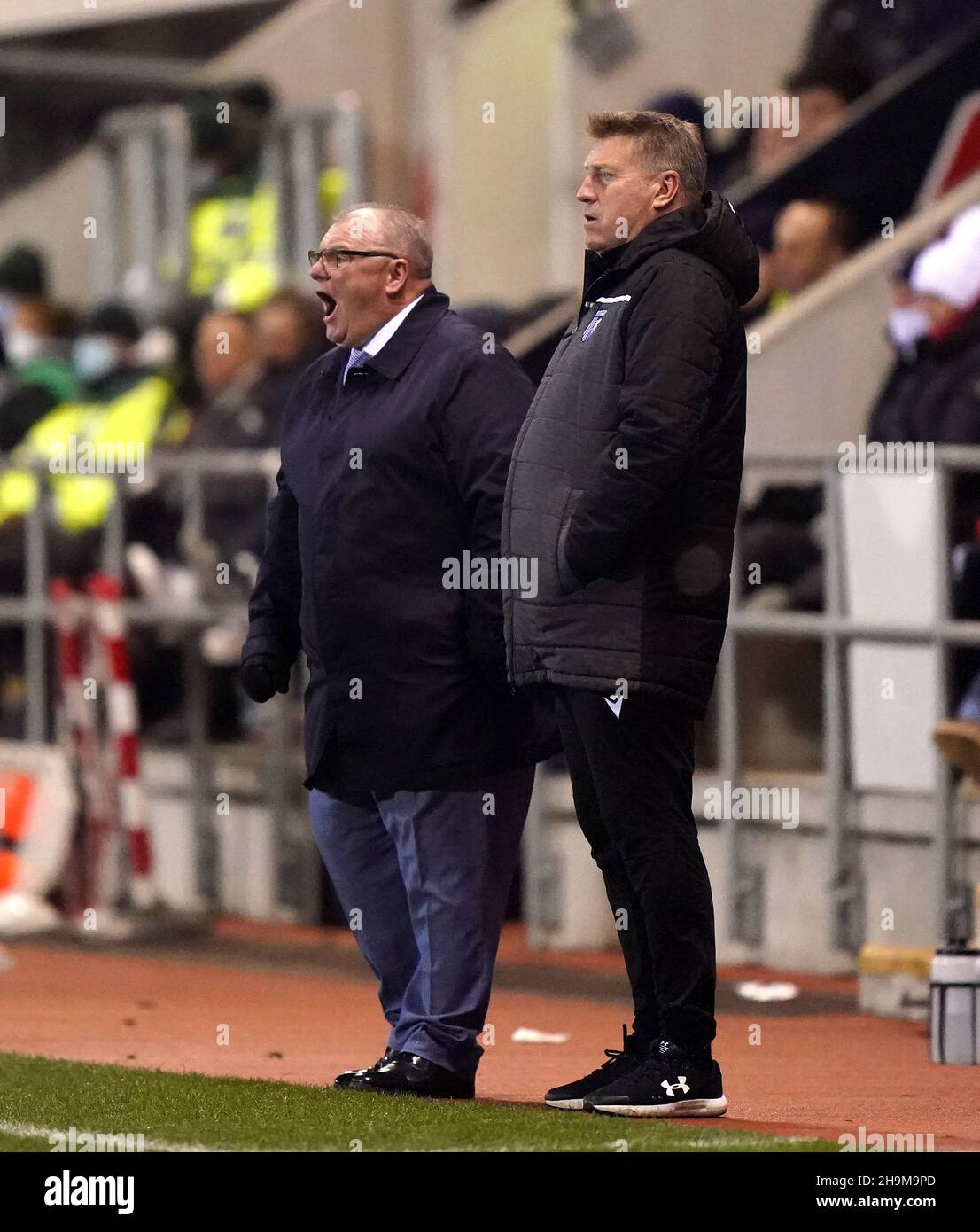 Gillingham manager Steve Evans (left) and assistant Paul Raynor on the touchline during the Sky Bet League One match at the AESSEAL New York Stadium, Rotherham. Picture date: Tuesday December 7, 2021. Stock Photo