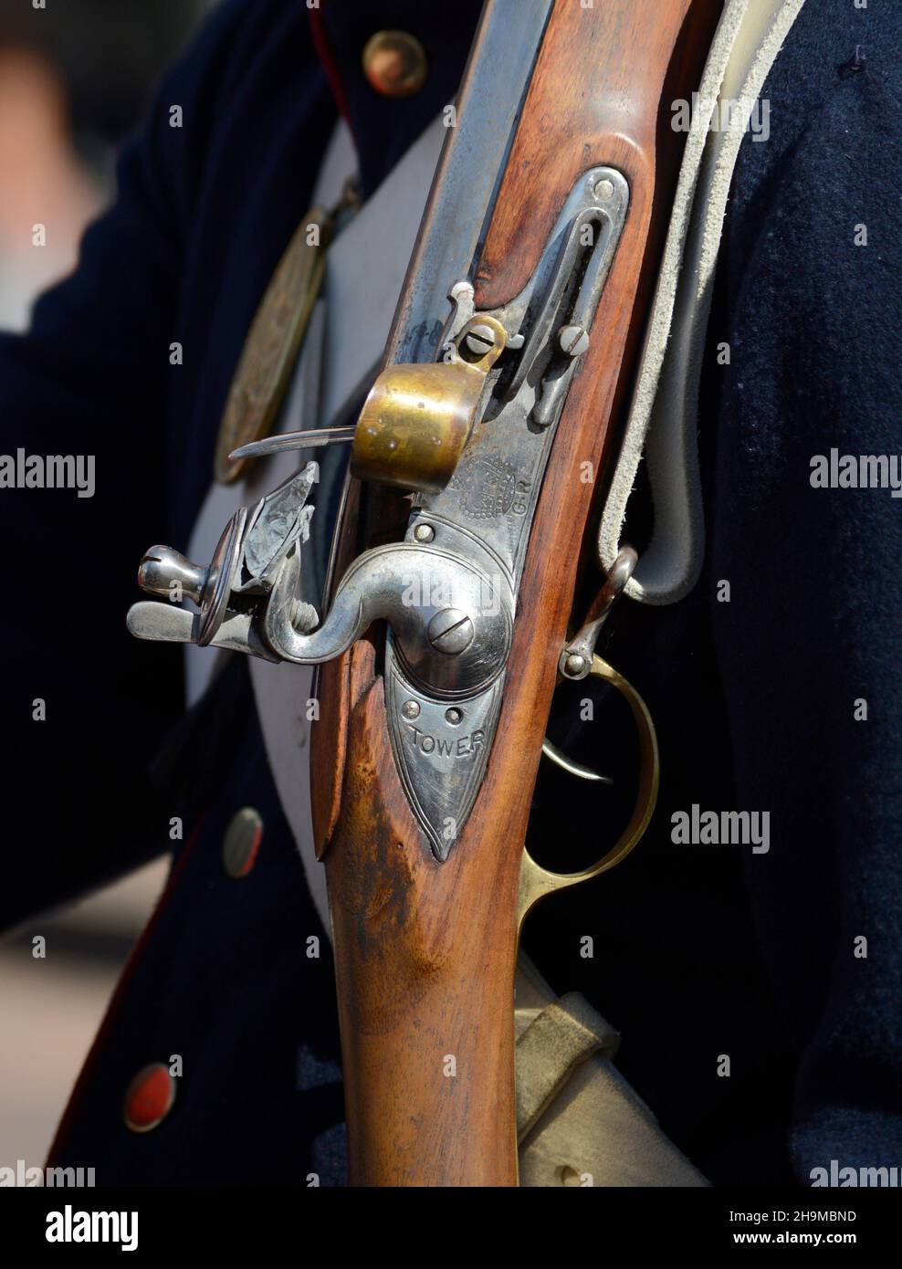 An historical reenactor holds a replica 19th century flintlock musket, or rifle, at an event in Santa Fe, New Mexico. Stock Photo