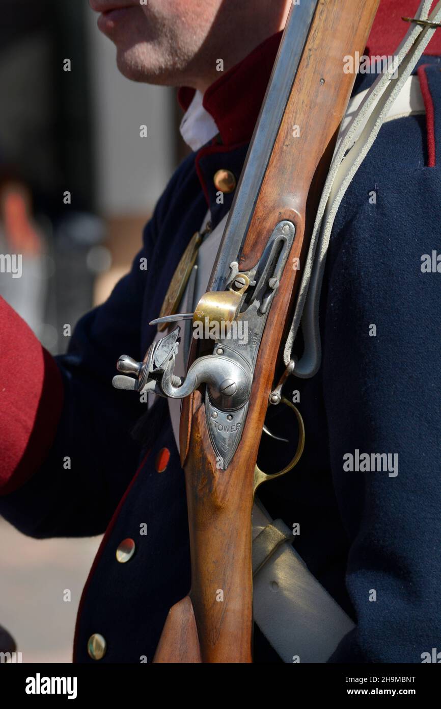 An historical reenactor holds a replica 19th century flintlock musket, or rifle, at an event in Santa Fe, New Mexico. Stock Photo