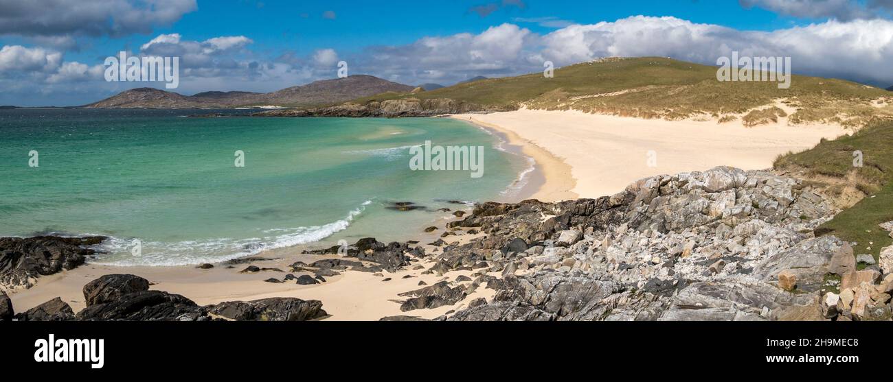 A panoramic view of rocks, sand and sea at the beautiful Traigh Iar beach with blue sky in Summer, Horgabost, Isle of Harris, Scotland, UK Stock Photo
