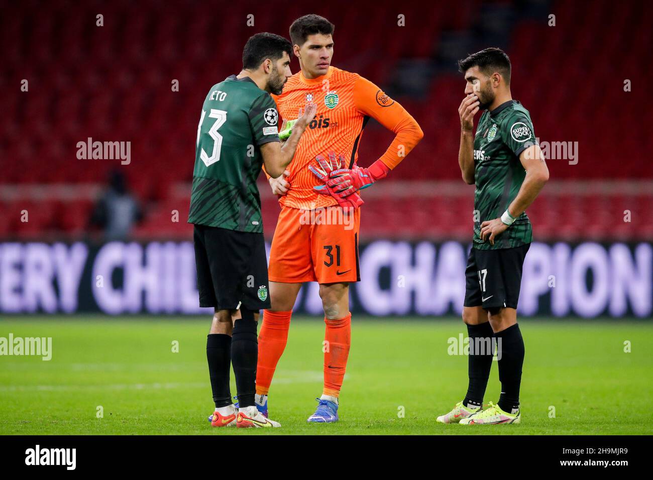 AMSTERDAM, NETHERLANDS - DECEMBER 7: Luis Neto of Sporting CP, Goalkeeper Joao Virginia of Sporting CP and Ricardo Esgaio of Sporting CP during the UEFA Champions League match between Ajax and Sporting Clube de Portugal at Johan Cruijff ArenA on December 7, 2021 in Amsterdam, Netherlands (Photo by Peter Lous/Orange Pictures) Stock Photo