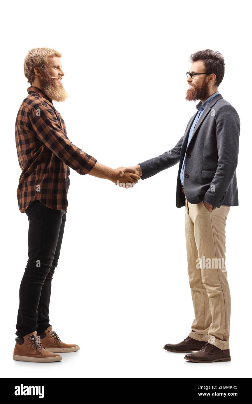 Full length profile shot of two bearded men shaking hands isolated on white background Stock Photo