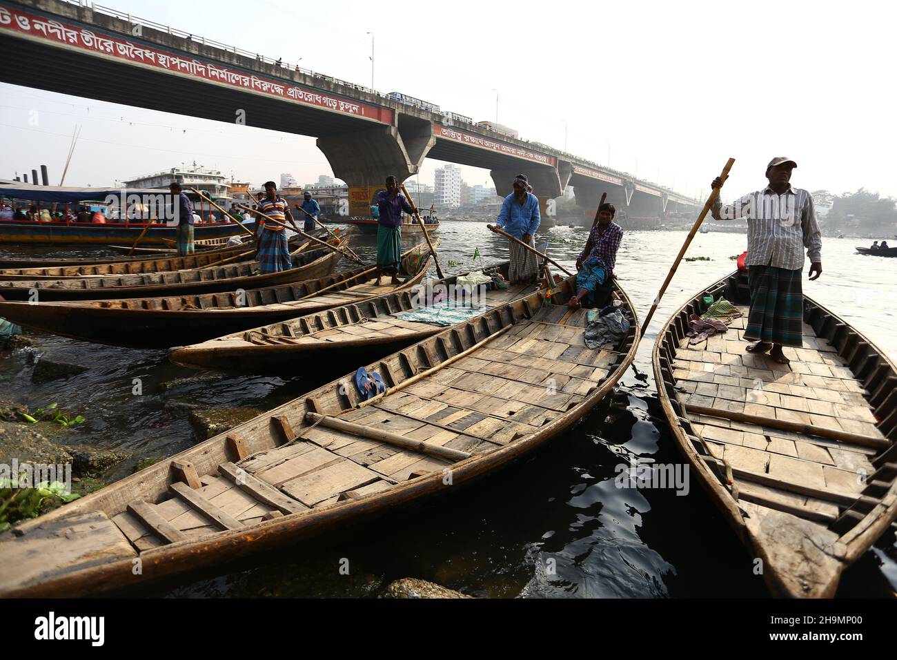 A Boatman under the bridge Waiting for customers in wharf. Stock Photo