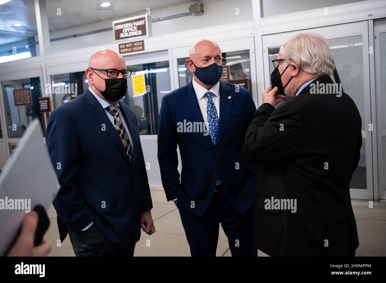 Washington, USA. 07th Dec, 2021. Twin brothers Former Astronaut Scott Kelly, left, and Senator Mark Kelly (D-AZ), right, wait for a train in the Senate Subway at the U.S. Capitol, in Washington, DC, on Tuesday, December 7, 2021. During a hectic week of negotiations on Capitol Hill, President Biden today will speak with Russian President Vladimir Putin about Russian troop build up on the border with Ukraine and the conflict there. (Graeme Sloan/Sipa USA) Credit: Sipa USA/Alamy Live News Stock Photo