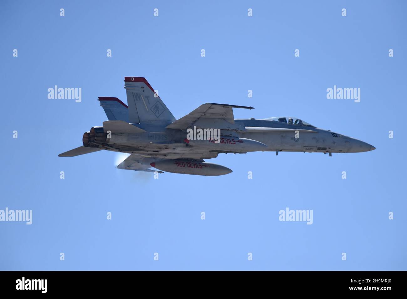 United States Marine Corps F/A-18C from VMFA-232, the  Red Devils on a high-speed flyby. Stock Photo