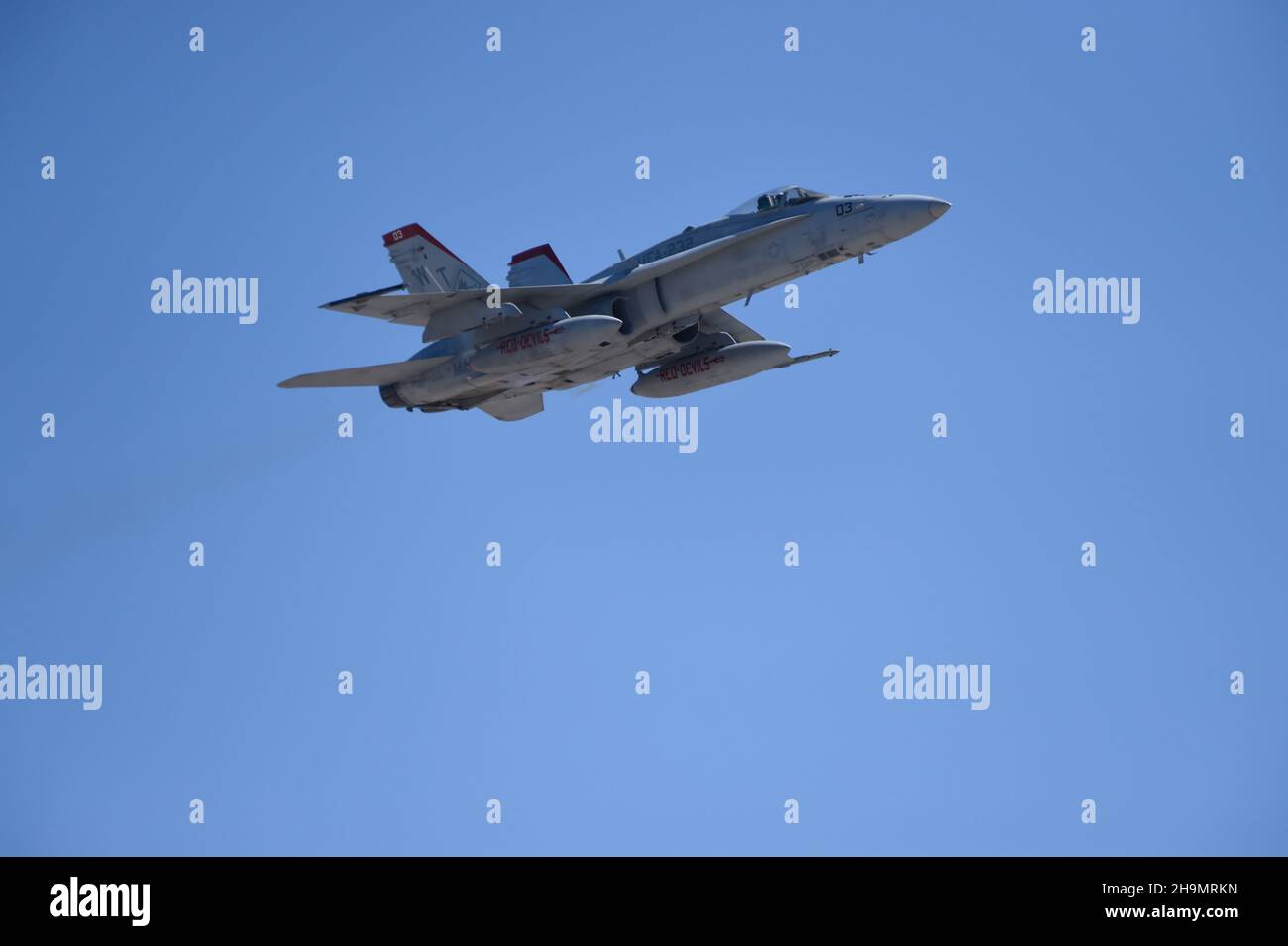 United States Marine Corps F/A-18C from VMFA-232, the  Red Devils on a high-speed flyby. Stock Photo