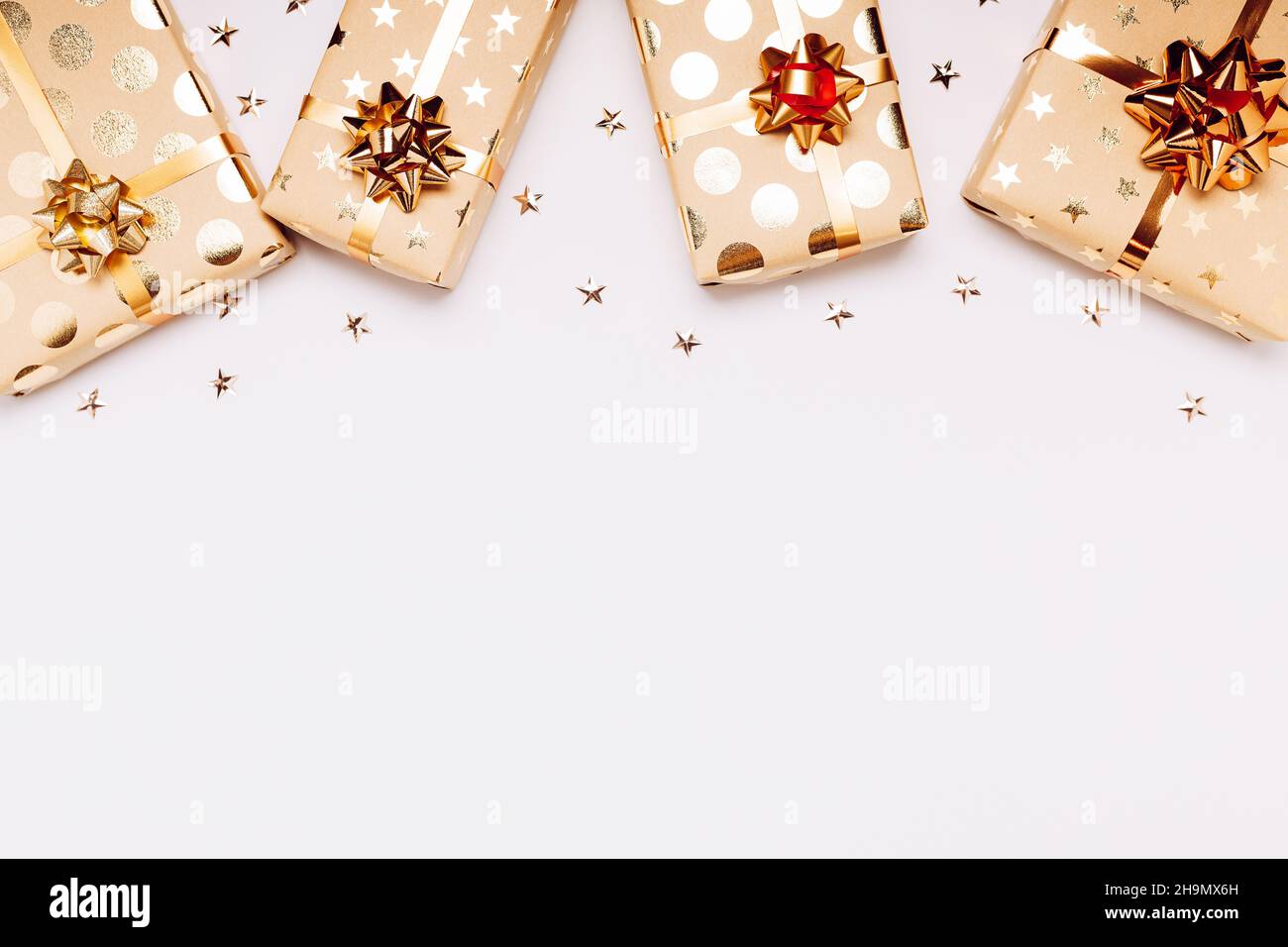 Gift boxes with golden bows on white background. Stock Photo