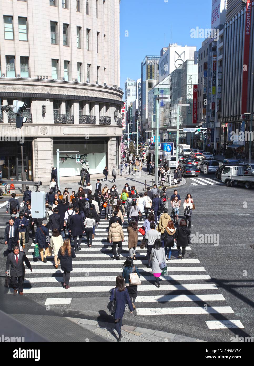 The pedestrian crossing with many people walking at the crossing between the Ricoh building and the Wako building in Ginza, Tokyo, Japan. Stock Photo