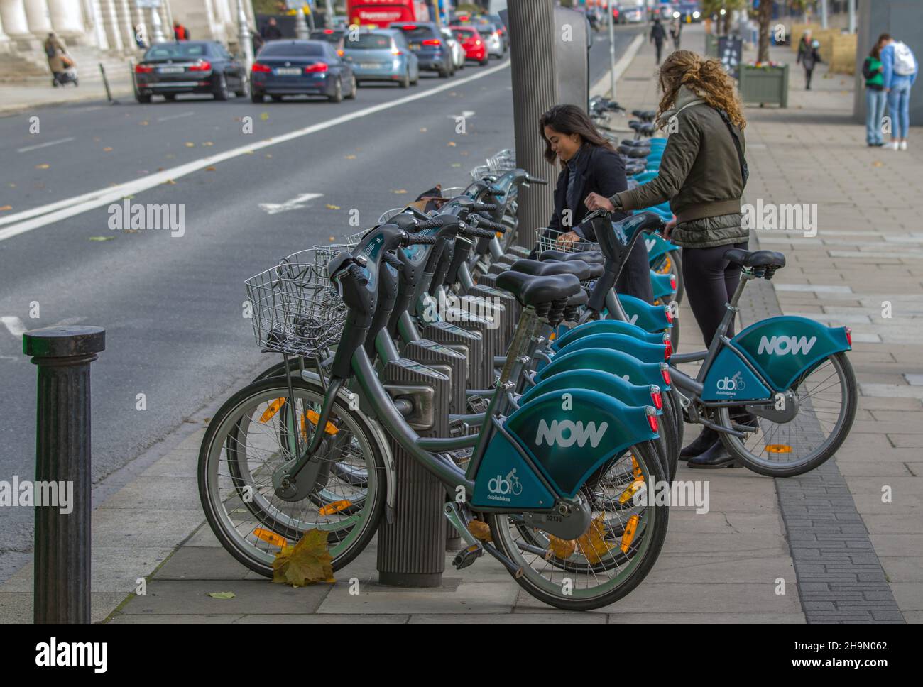 Dublin bike station, bike station full of bikes, girls are taking city