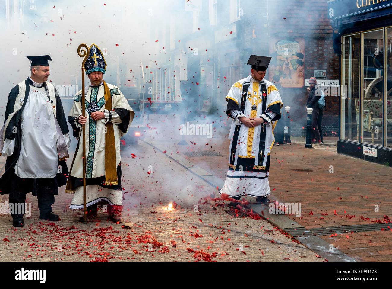Cliffe Bonfire Society Members Dressed In Religious Costume Set Off Firecrackers In The Street Before The Annual Bonfire Night Celebrations, Lewes, UK Stock Photo