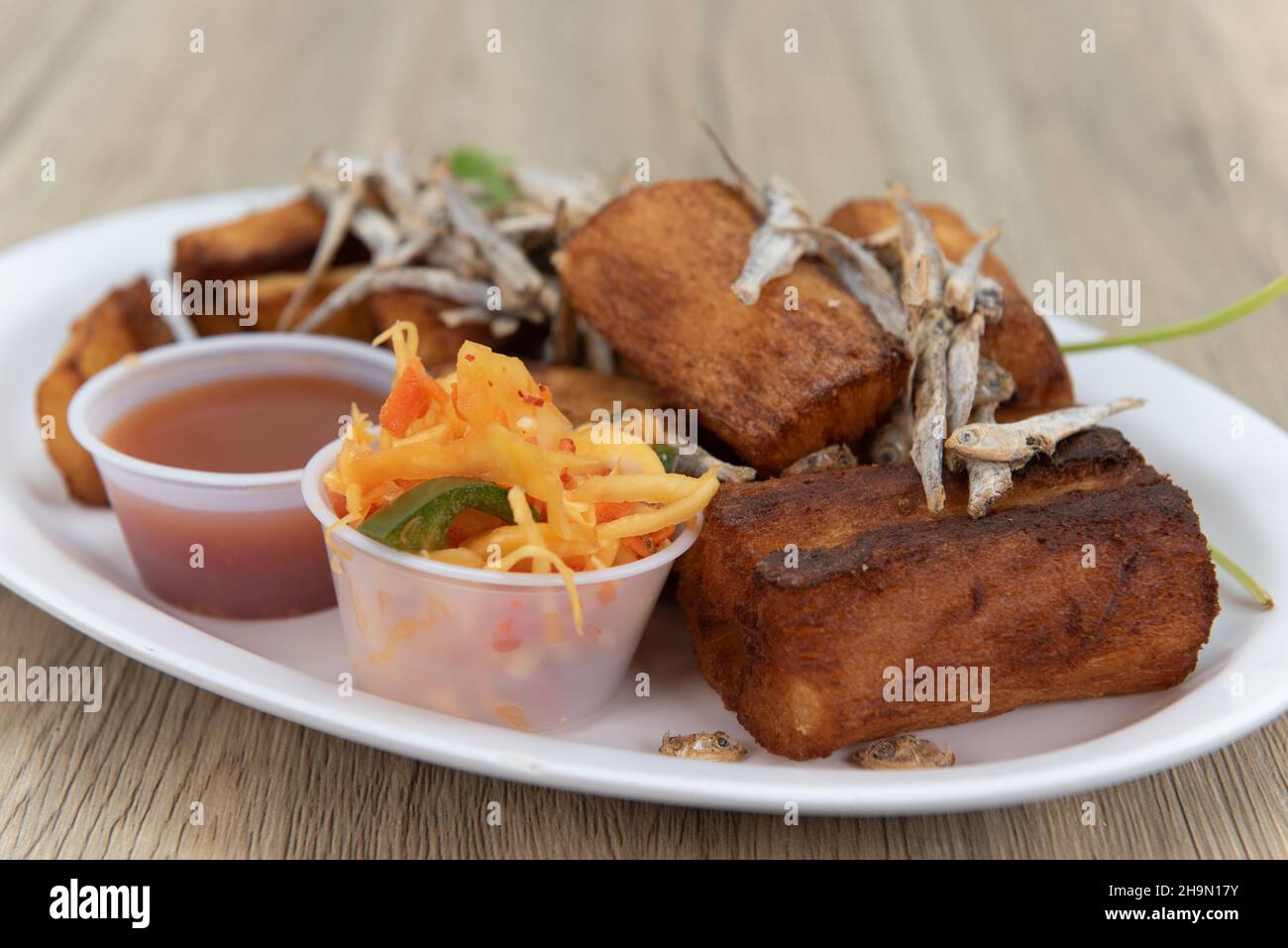 Fried Yucca root with garnished with dried fish and dipping sauce for a
