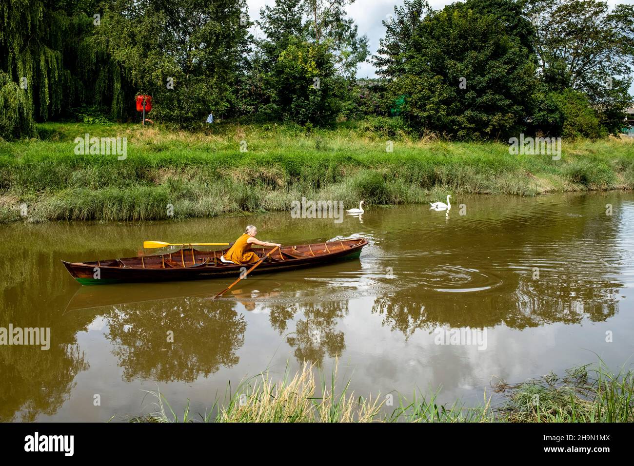 A Woman Rowing A Boat On The River Ouse, Lewes, East Sussex, UK Stock