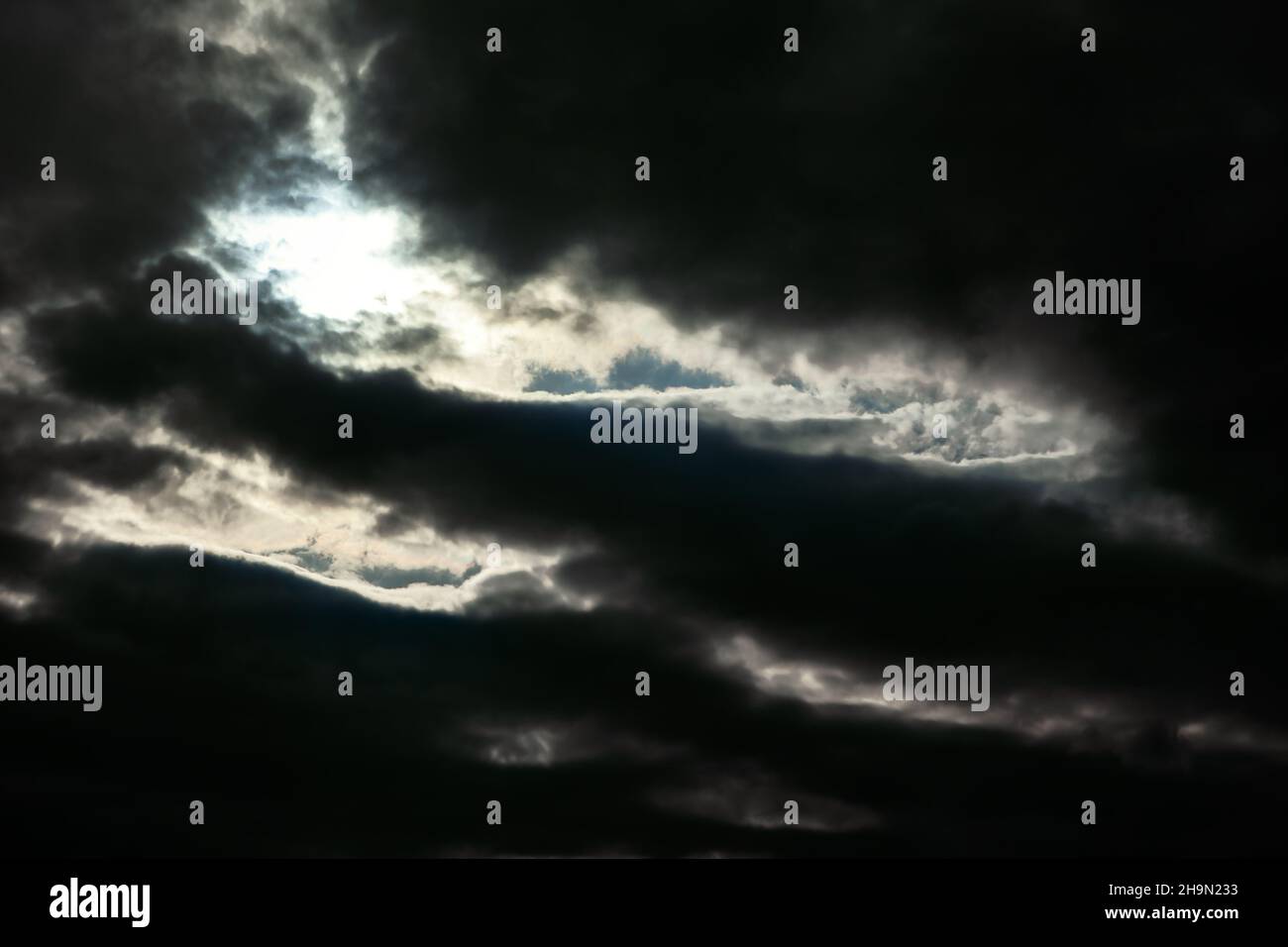 Gloomy sky with black clouds . Light at darkness Stock Photo