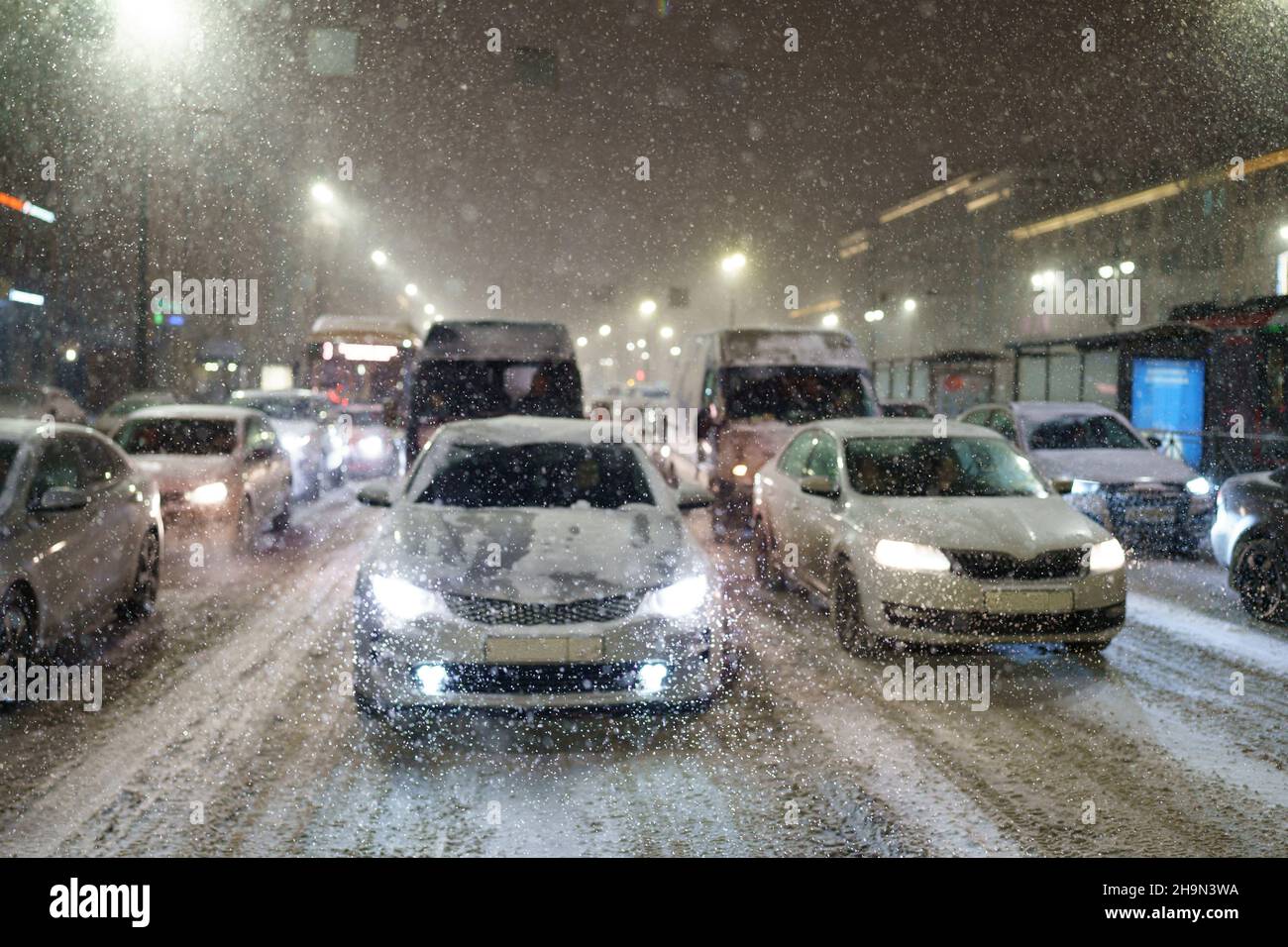 Snowfall and traffic collapse city. Cars standing in jam on road due to snow  storm, bad visibility Stock Photo - Alamy