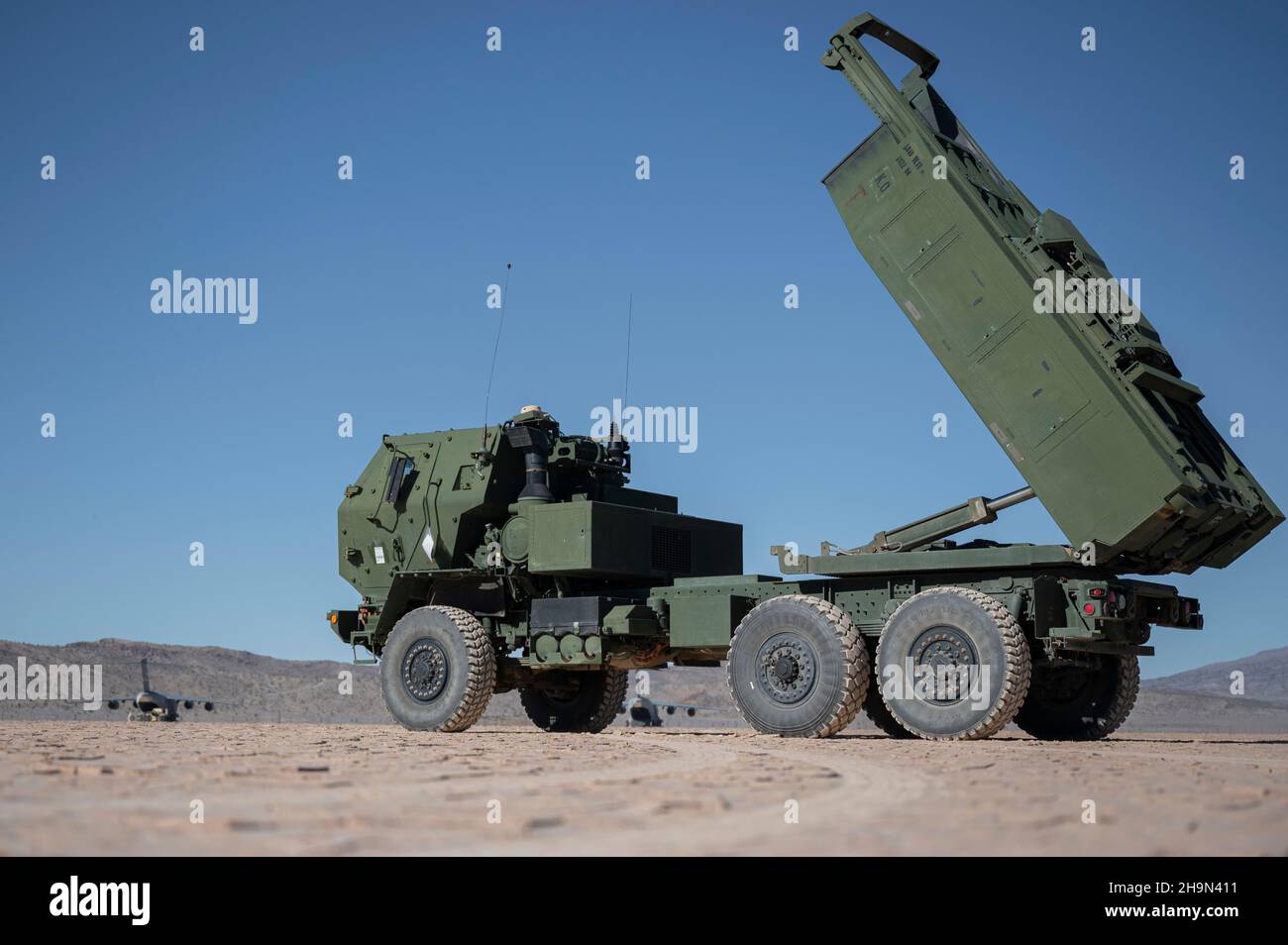An M142 High Mobility Artillery Rocket System (HIMARS) assigned to the 3rd Battalion, 321st Field Artillery Regiment, Fort Bragg, North Carolina, simulates launching artillery during U.S. Air Force Weapons School Integration held at Nellis Air Force Base, Nevada, Dec. 4, 2021. The 6th Airlift Squadron staged at Nellis AFB to load HIMARS’s as part of the Joint Forcible Entry 21B exercise. (U.S. Air Force photo by Airman 1st Class Zachary Rufus) Stock Photo