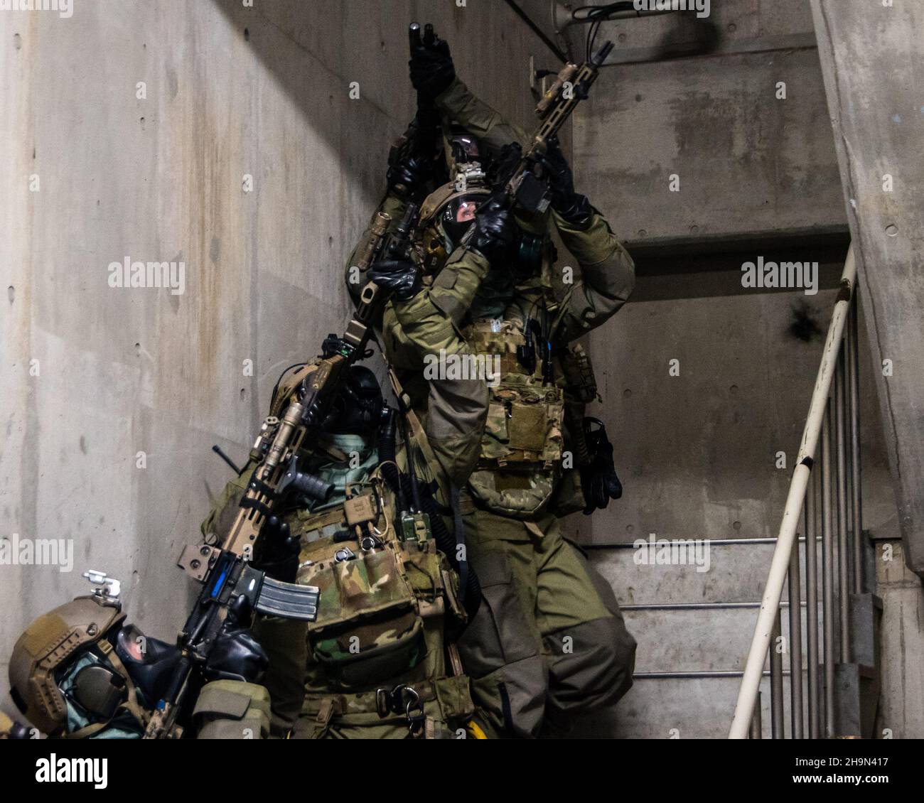 Green Berets with 1st Battalion, 1st Special Forces Group (Airborne), alongside navy explosive ordnance technicians from Platoon 532, clear a stairwell while conducting direct action training operations on mainland Japan, Oct. 26, 2021.  The training was held under Chemical, Biological, Radiological, and Nuclear (CBRN) simulated conditions in order to maintain their lethality and crisis response readiness in the Indo-Pacific. (U.S. Army Courtesy Photo) Stock Photo